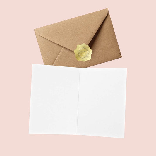 Blank interior of the Te Amo Spanish love card, shown with a kraft envelope and gold heart seal on a pink background.